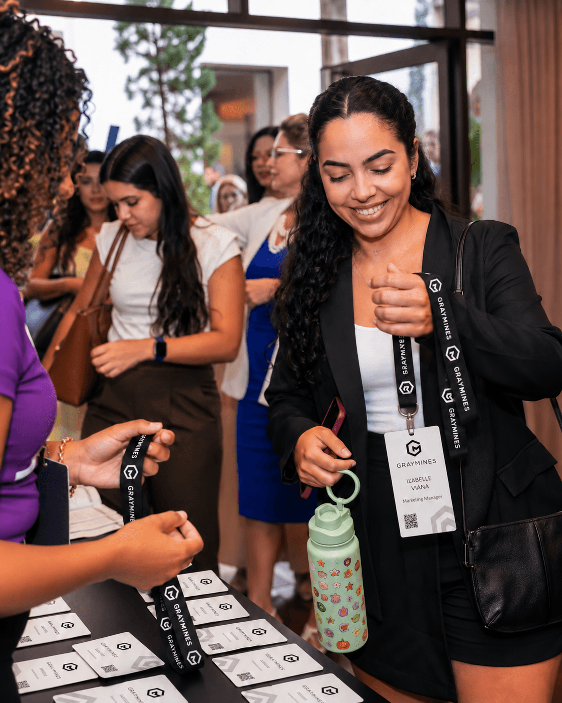 Guests collecting Gray Mines lanyards and badges at the registration table