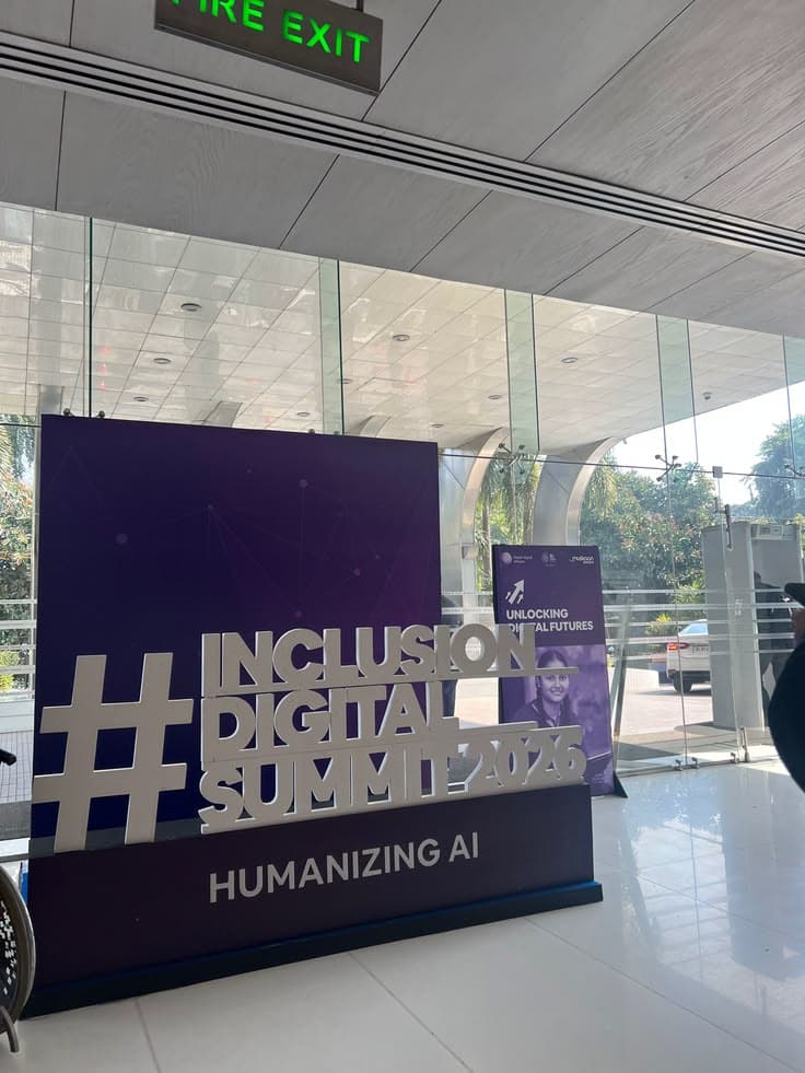 The summit's sign in a glass lobby: #Inclusion Digital Summit, Humanizing AI